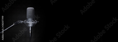 Studio recording microphone in the dark banner