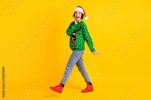 Full body profile side photo shocked crazy girl santa claus headwear go walk house x-mas christmas tradition gift present delivery wear reindeer decor sweater isolated bright color background
