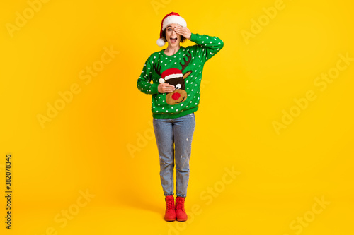 Full length photo crazy shocked girl santa claus headwear impressed x-mas christmas gift close cover hands eyes face deer decor pullover wear jeans isolated bright shine color background