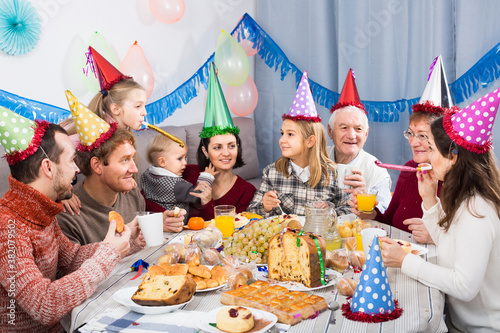 Large happy american family having fun during children birthday party
