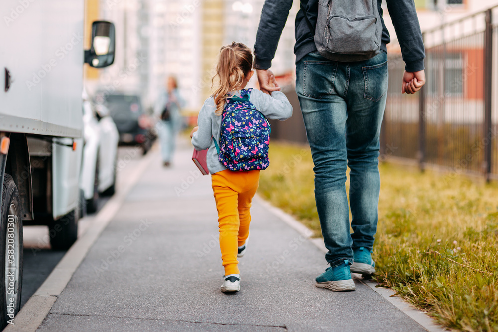 Father and daughter going to school for the first time. Back to school after pandemic.