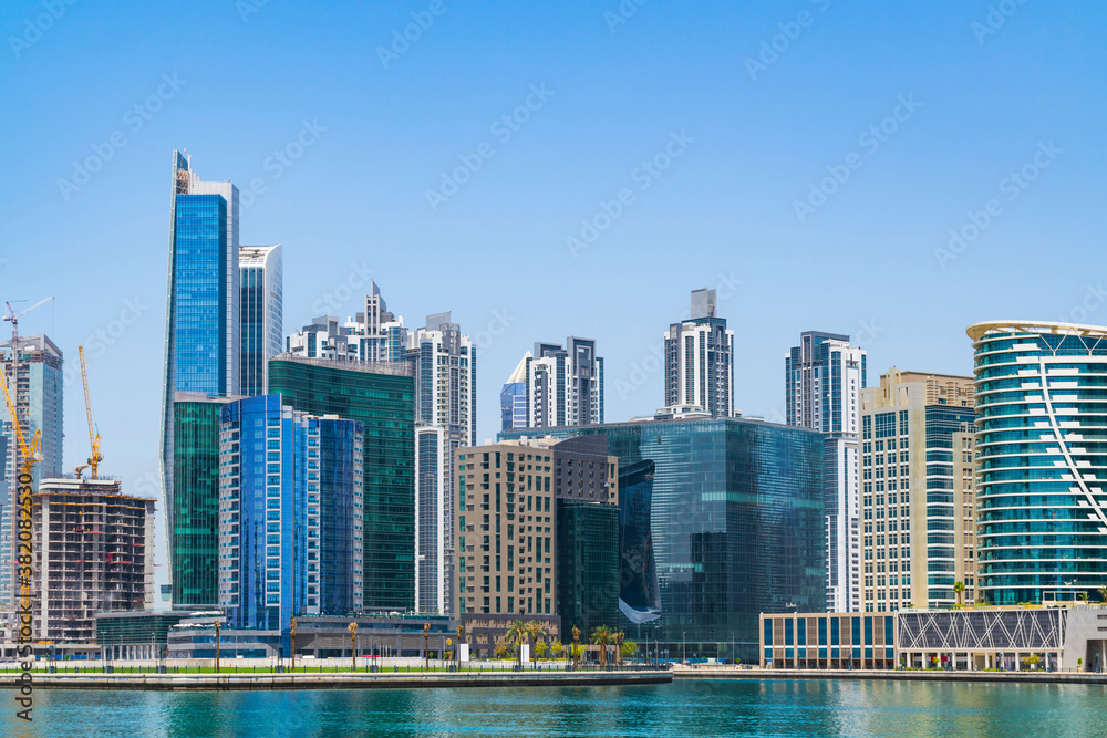 Cityscape skyscrapers of downtown of Dubai, UAE at a sunny day at Dubai Canal, Business Bay. Modern skyline of the capital of the Emirate of Dubai. A center of international trading of Western Asia