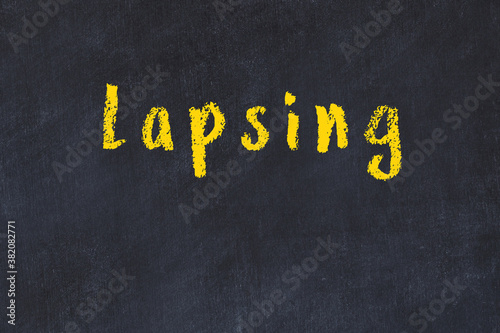 Fotografie College chalk desk with the word lapsing written on in