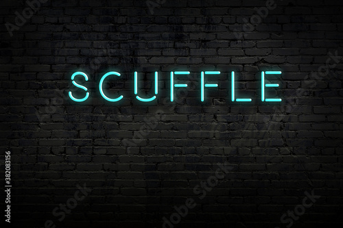 Night view of neon sign on brick wall with inscription scuffle