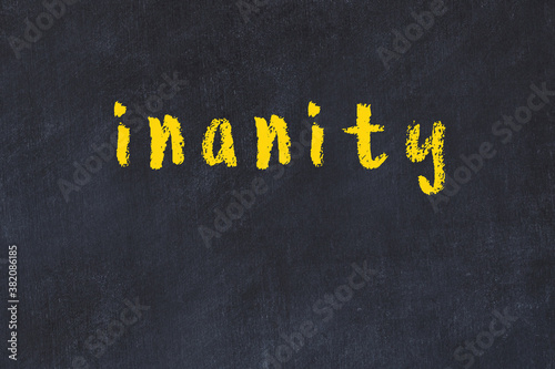 Obraz na plátně College chalk desk with the word inanity written on in
