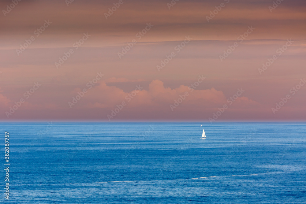 Small sailboats in the sea from the Punta Nariga Lighthouse. Malpica de Bergantiños, La Coruña, Galicia, Spain. Coast of Death.