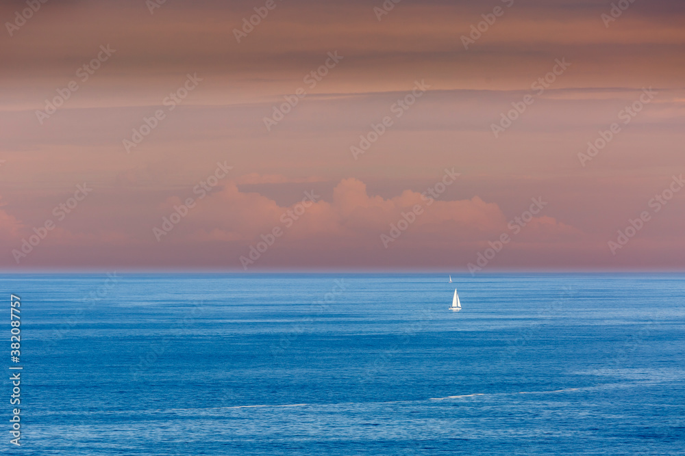 Small sailboats in the sea from the Punta Nariga Lighthouse. Malpica de Bergantiños, La Coruña, Galicia, Spain. Coast of Death. Small sailboats in the sea from the Punta Nariga Lighthouse. Malpica de Bergantiños, La Coruña, Galicia, Spain. Coast of Death.