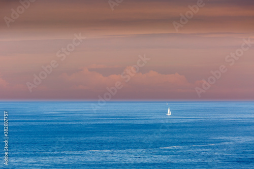 Small sailboats in the sea from the Punta Nariga Lighthouse. Malpica de Bergantiños, La Coruña, Galicia, Spain. Coast of Death.