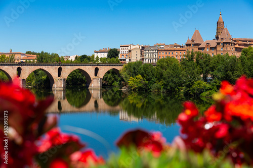 Medieval bridge over the Tarn river in Montauban city on sunny day. France photo