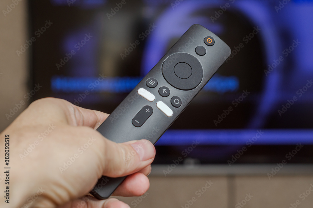 hand holds a tv box remote control hand holds a tv box remote control