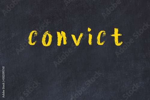Fotografi College chalk desk with the word convict written on in