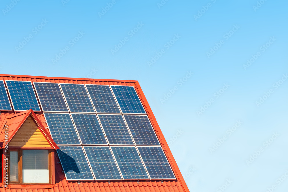solar panels on the red roof of the building on a sunny day