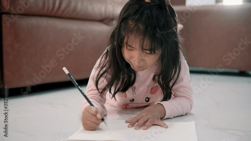 Child girl writing on a paper for learning, children education concept