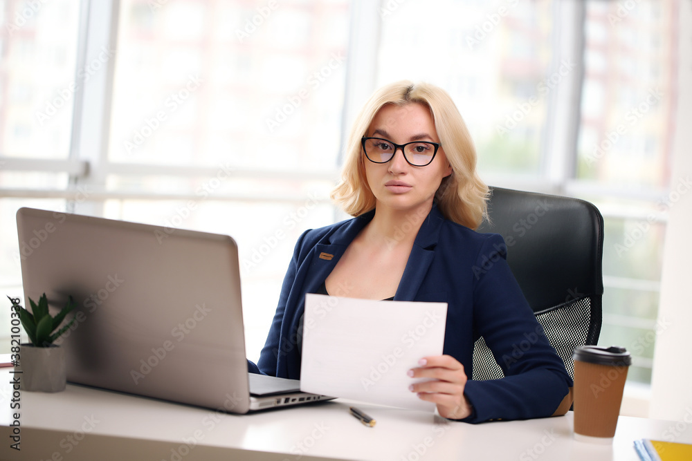 Beautiful business woman dreaming while working on computer at her office Beautiful business woman dreaming while working on computer at her office