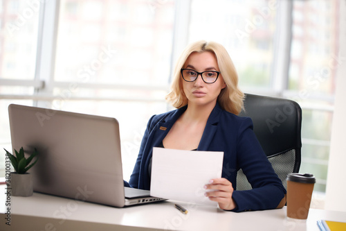 Beautiful business woman dreaming while working on computer at her office