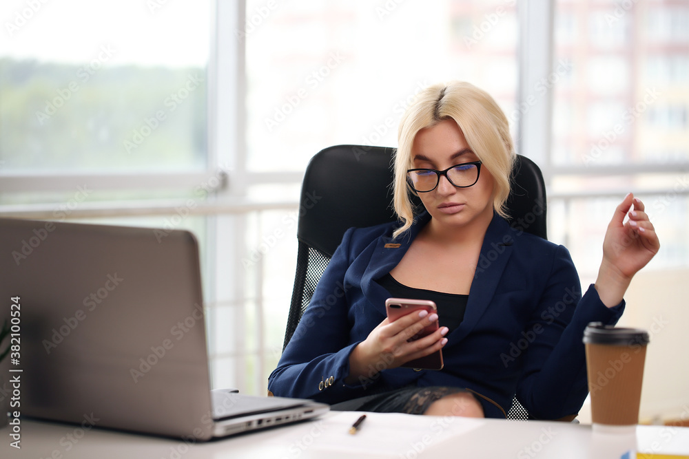 Handsome student in suit sitting at desk with laptop Handsome student in suit sitting at desk with laptop