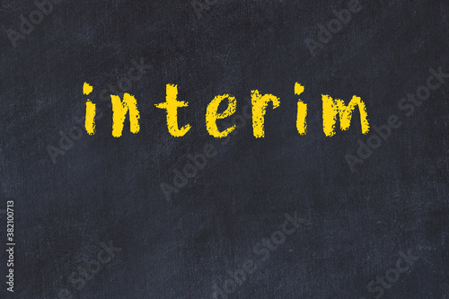 College chalk desk with the word interim written on in photo