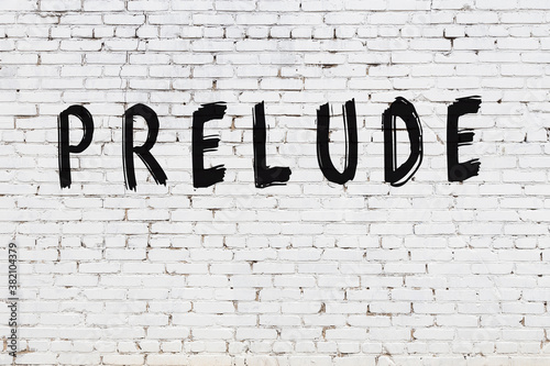 Inscription prelude painted on white brick wall