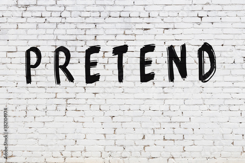 White wall with black paint inscription pretend on it