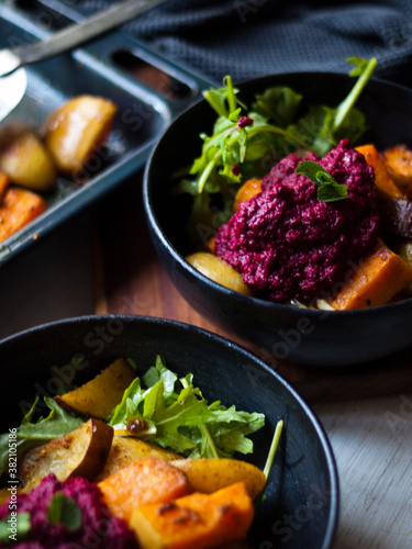 Home made roast vegetables with arugula and beetroot puree. Natural light.