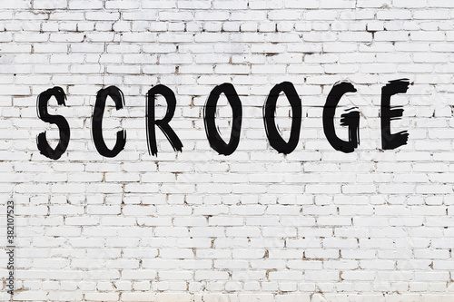 Schilderij op canvas Inscription scrooge painted on white brick wall