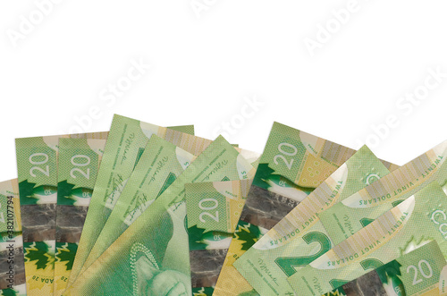 20 Canadian dollars bills lies on bottom side of screen isolated on white background with copy space. Background banner template photo