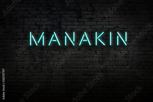 Obraz na plátně Neon sign. Word manakin against brick wall. Night view