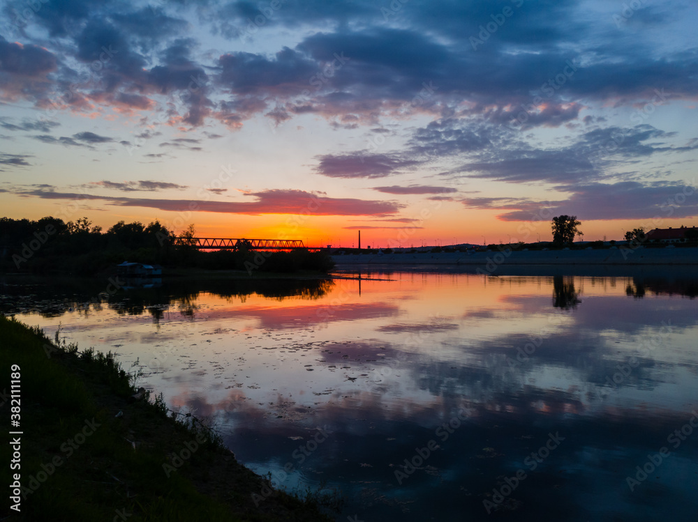 A reflection of a colorful sunset in the river Sava in Bosanski Brod
