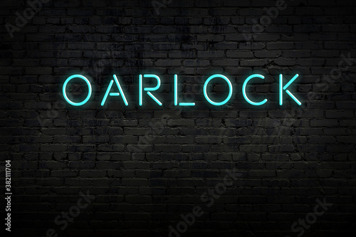 Night view of neon sign on brick wall with inscription oarlock photo