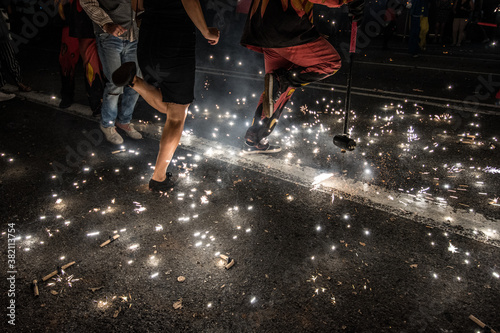 Correfoc. People dancing at night with fire sparks among their feet in a popular tradition in Catalonia.