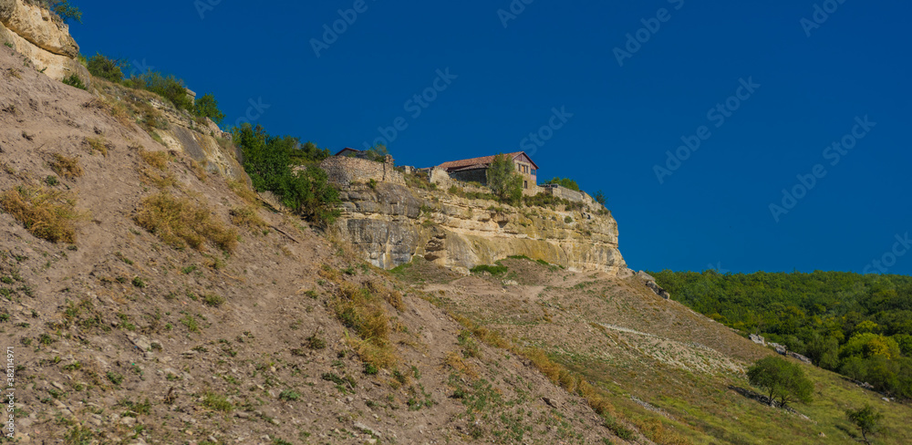 the remains of a medieval fortress city (according to other sources - a monastery) Tepe-Kermen, covering the upper part of the mountain in several tiers the remains of a medieval fortress city (according to other sources - a monastery) Tepe-Kermen, covering the upper part of the mountain in several tiers