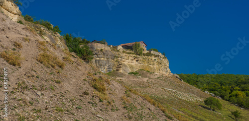 the remains of a medieval fortress city (according to other sources - a monastery) Tepe-Kermen, covering the upper part of the mountain in several tiers