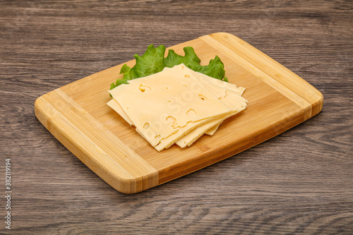 Sliced yellow cheese over board