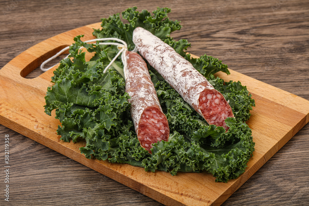 Spanish Fuet sausage with salad leaves Spanish Fuet sausage with salad leaves