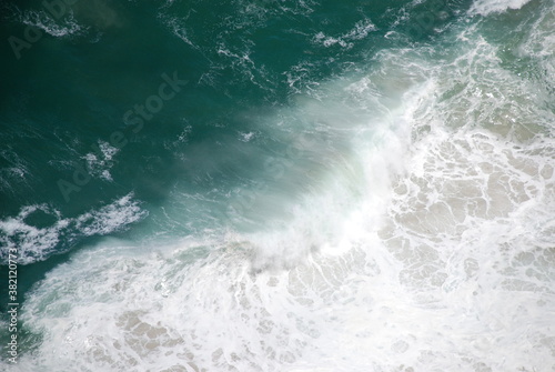 Abstract wild coast line with sea foam and crashing waves shot from above. Birdseye/aerial view. Shot in South Africa.
