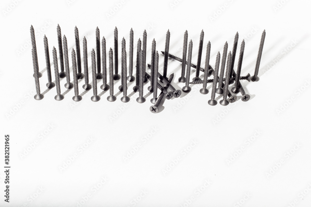Self-tapping screws for sheet metal with a pressure pad on a white background, galvanized. Self-tapping screws are lined up Self-tapping screws for sheet metal with a pressure pad on a white background, galvanized. Self-tapping screws are lined up