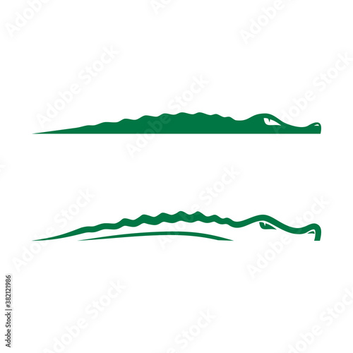 Fotobehang the logo of a swimming crocodile