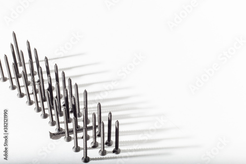 Self-tapping screws for sheet metal with a pressure pad on a white background  galvanized. Self-tapping screws are lined up