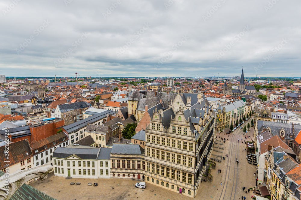 Cityscape with houses, buildings and streets in the city center of Ghent, aerial view of the touristic city on a cloudy day with a sky covered with thick clouds in Belgium