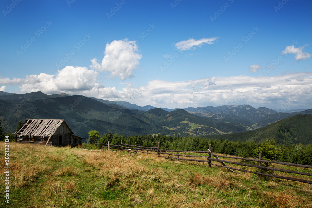 Beautiful mountain landscape. Old wooden house in the mountains