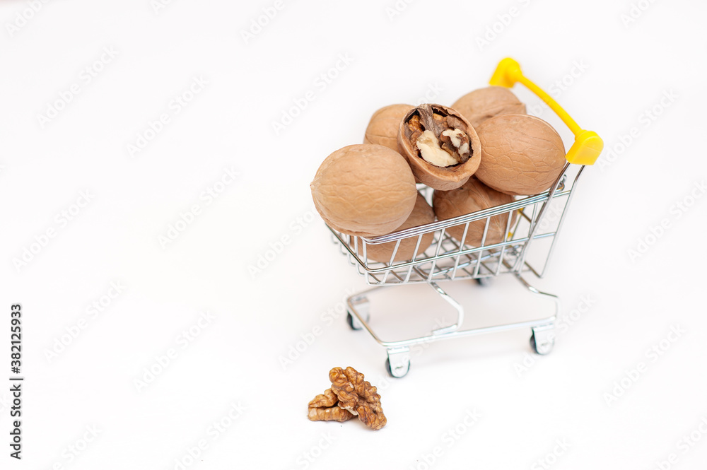 walnuts in a cart on a white background