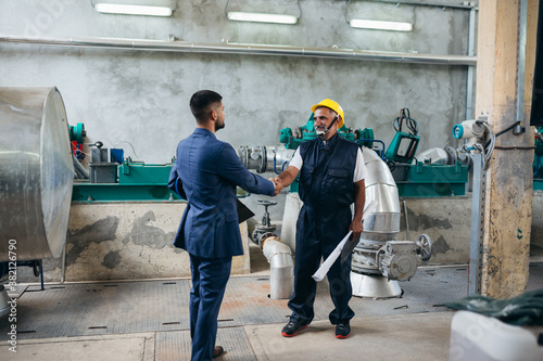 industrial worker and supervisor handshake