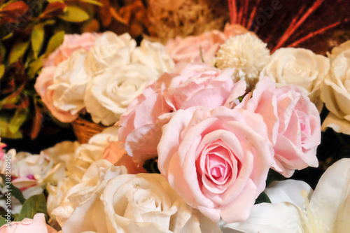 bouquet of roses in vase. Yellow, Red and Orange Rose Foral Background. Beautiful flowers as background. Close up flowers background colourfu purple Gerbera flowering in garden,Summer or Spring day 