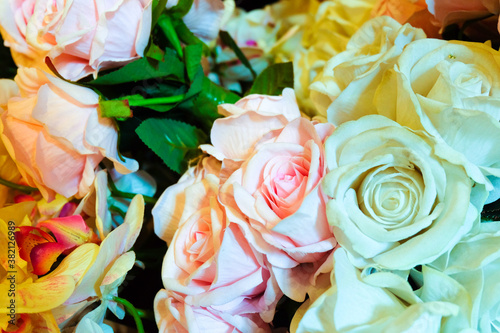 bouquet of roses in vase. Yellow, Red and Orange Rose Foral Background. Beautiful flowers as background. Close up flowers background colourfu purple Gerbera flowering in garden,Summer or Spring day 