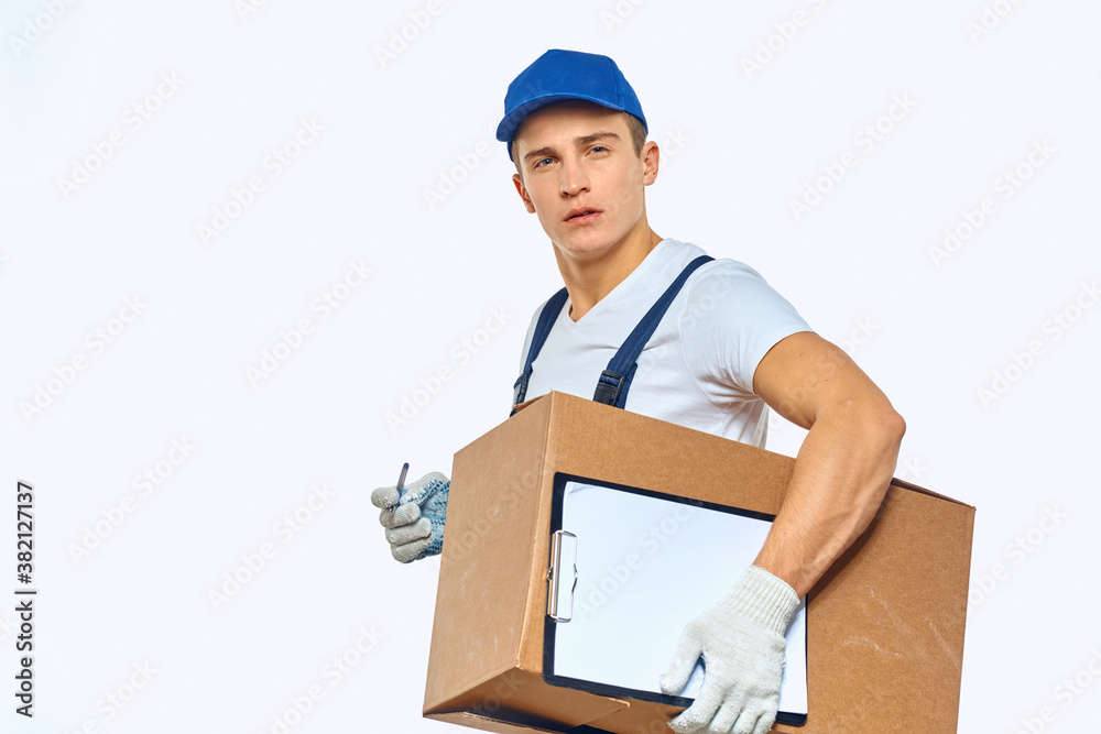Man worker with box in hands delivery loading service work light background Man worker with box in hands delivery loading service work light background