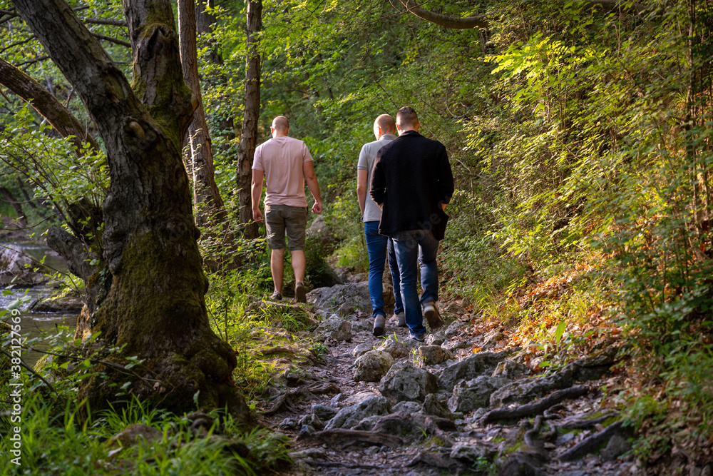 Three friends talking a walk through beautiful nature around river Gradac