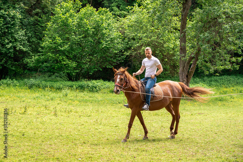 Young man enjoying horseback riding © Kizaru