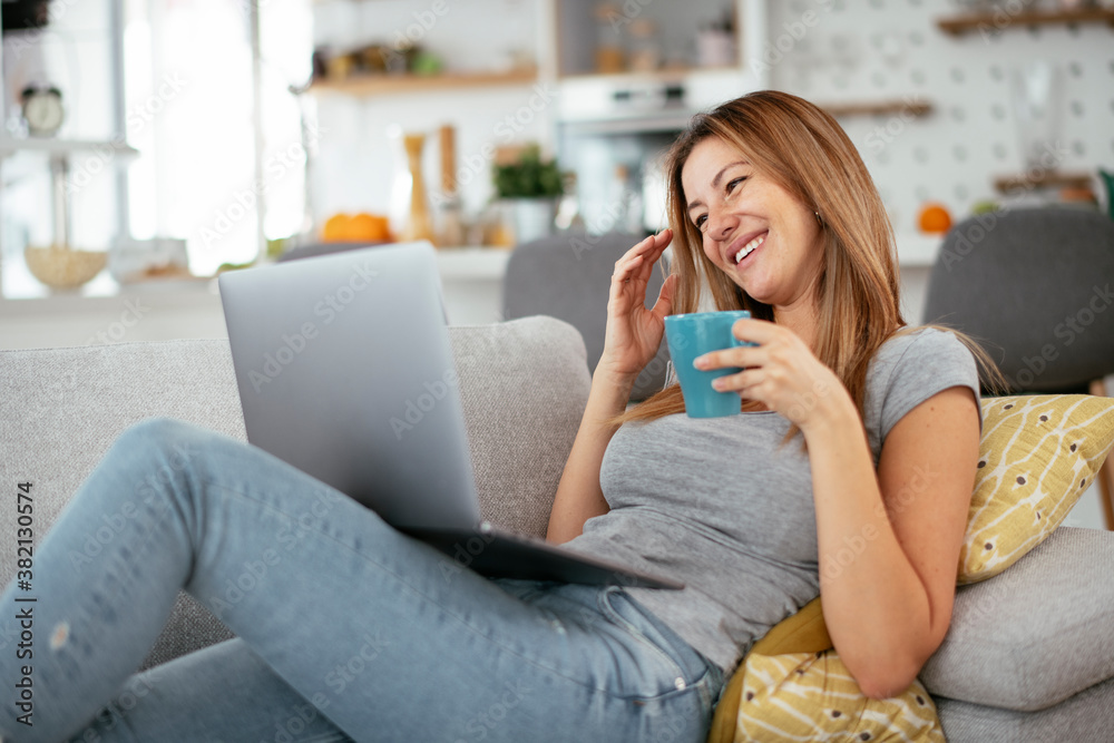 Young woman having video call. Beautiful woman enjoying at home...