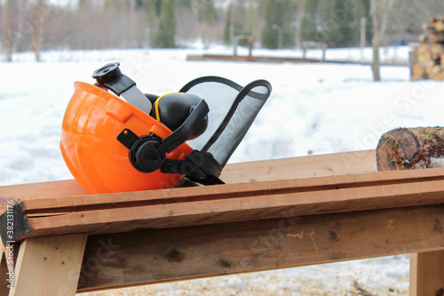 Helmet for chainsaw users lying on sawhorse