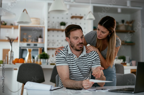 Husband and wife preparing bills to pay. Young couple having financial problems.